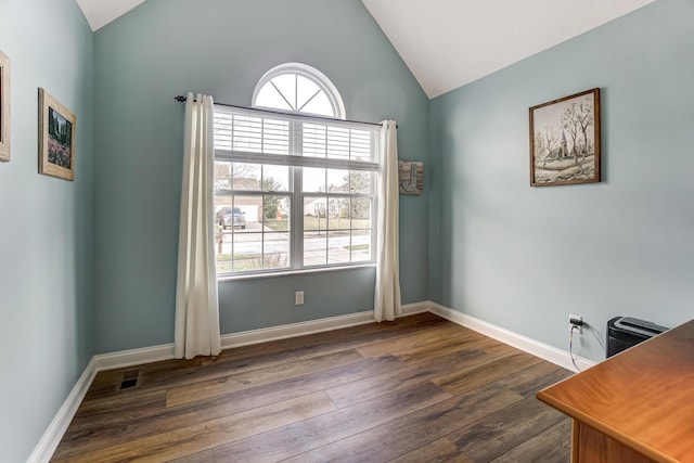 unfurnished office with vaulted ceiling, a wealth of natural light, and dark wood-type flooring