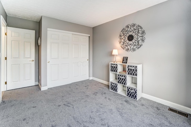 unfurnished bedroom featuring carpet floors and a closet