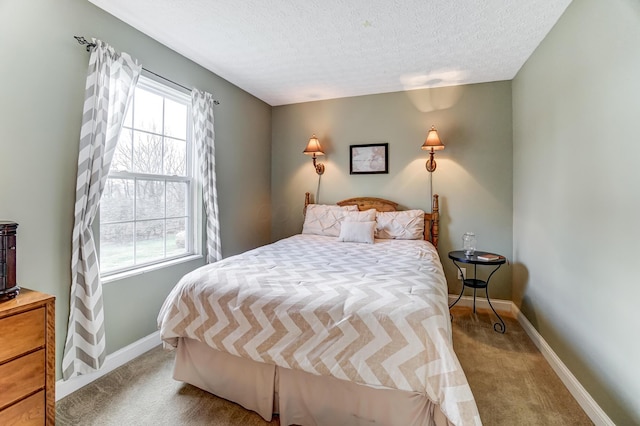 carpeted bedroom featuring a textured ceiling and multiple windows