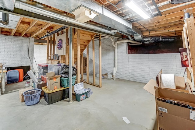 basement featuring brick wall