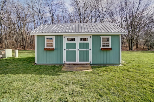 view of outdoor structure featuring a lawn