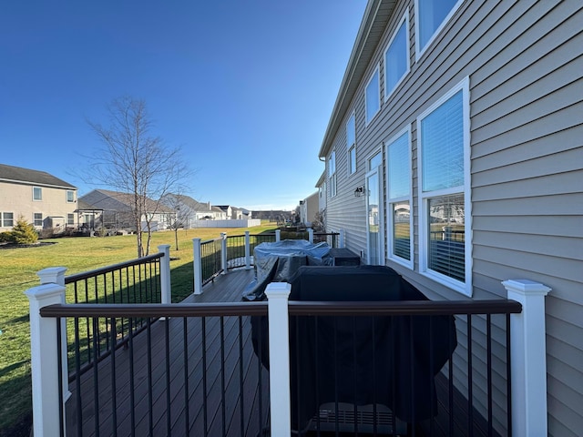 wooden deck featuring a lawn