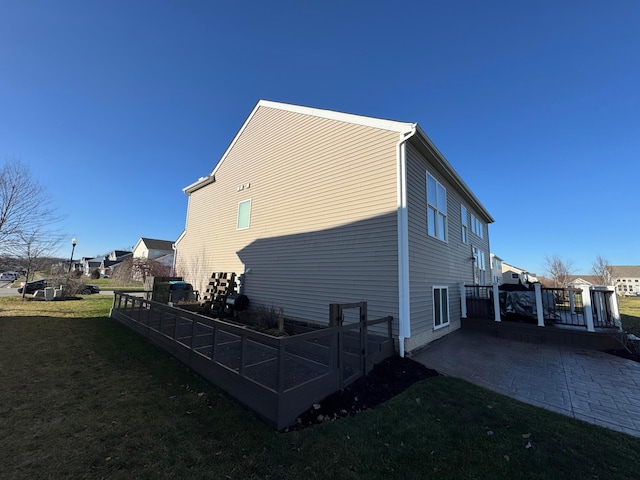 view of property exterior featuring a patio area and a yard