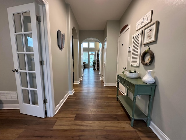 hallway with french doors and dark hardwood / wood-style floors