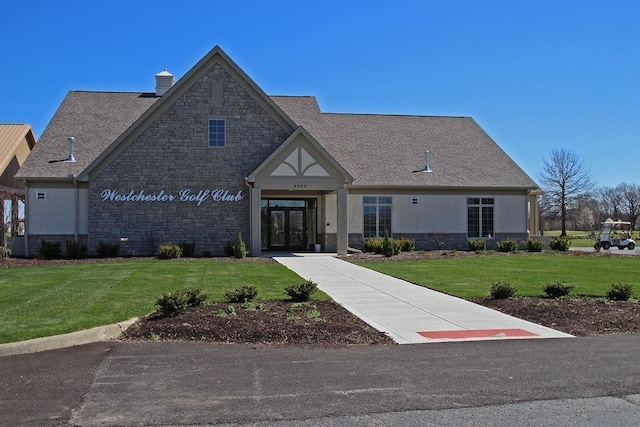 view of front of property with french doors and a front lawn