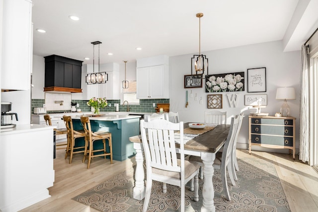 dining room featuring a notable chandelier and light hardwood / wood-style flooring