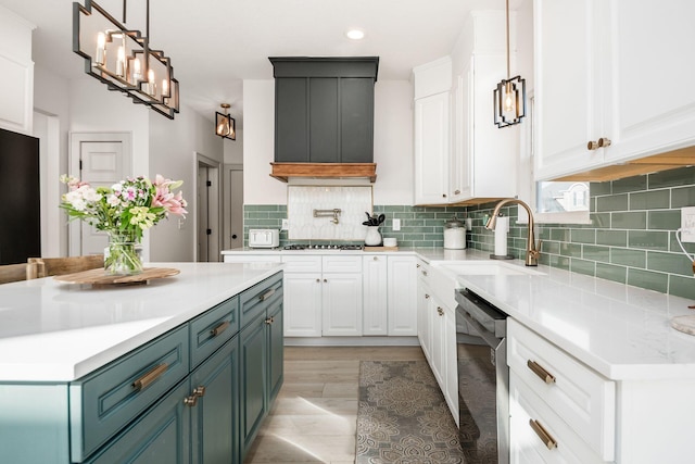 kitchen featuring blue cabinetry, sink, white cabinetry, stainless steel appliances, and decorative backsplash