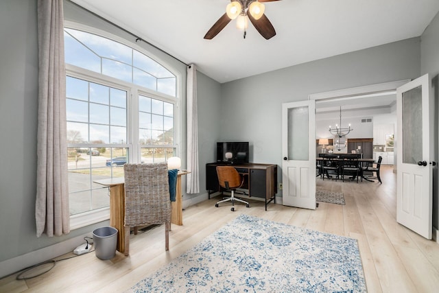 office with hardwood / wood-style flooring and ceiling fan with notable chandelier