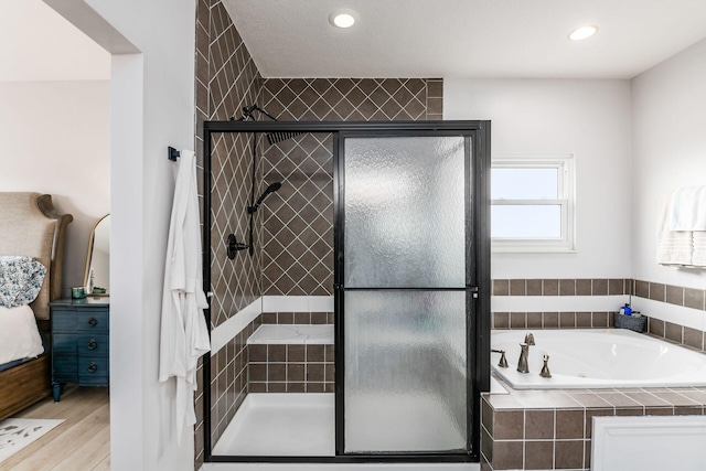 bathroom with hardwood / wood-style flooring and plus walk in shower