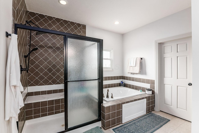 bathroom featuring tile patterned flooring and shower with separate bathtub