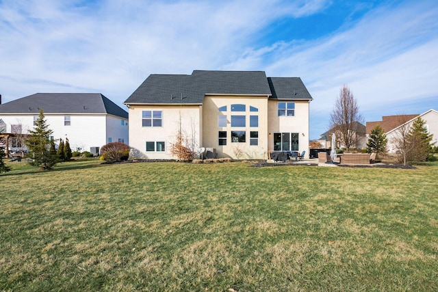 back of house with a lawn and a patio area