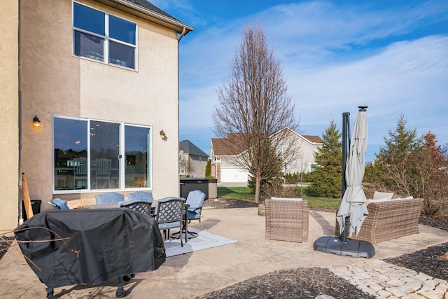 view of patio / terrace featuring outdoor lounge area, grilling area, and a jacuzzi