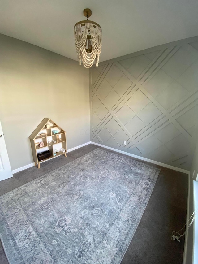 unfurnished dining area featuring a chandelier and dark carpet