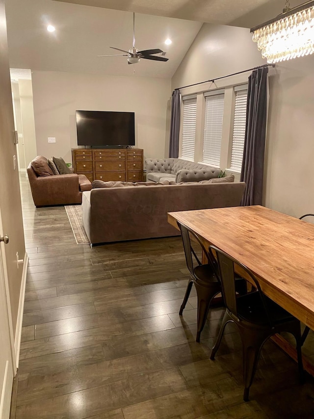 living room featuring vaulted ceiling, dark hardwood / wood-style floors, and ceiling fan