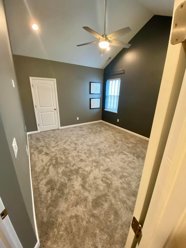 unfurnished room featuring carpet floors, high vaulted ceiling, and ceiling fan