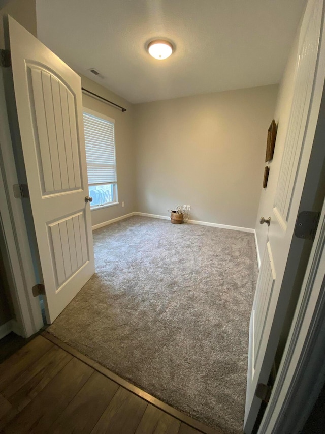 unfurnished bedroom featuring dark hardwood / wood-style floors