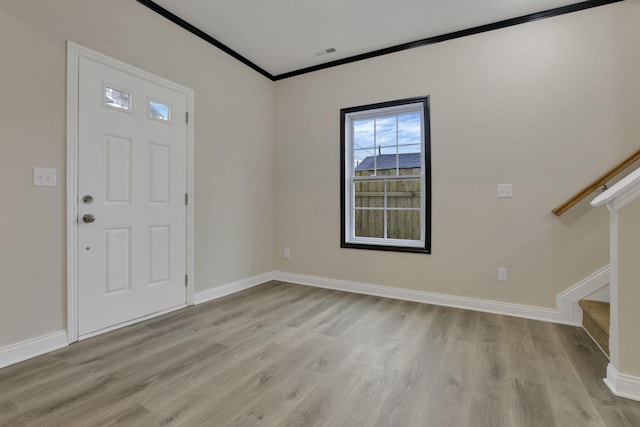 entrance foyer featuring light hardwood / wood-style flooring and crown molding