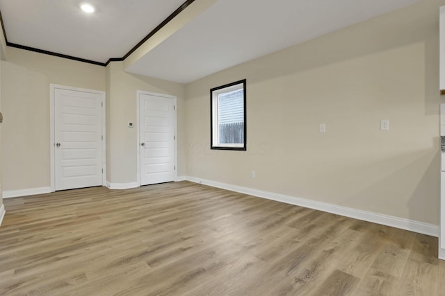 unfurnished bedroom with light hardwood / wood-style floors and ornamental molding