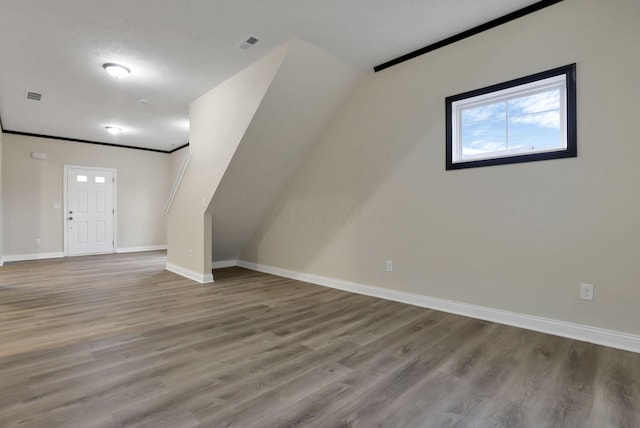 additional living space featuring light hardwood / wood-style floors