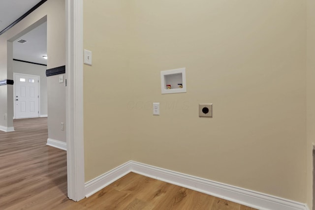 clothes washing area with hookup for an electric dryer, washer hookup, and hardwood / wood-style flooring