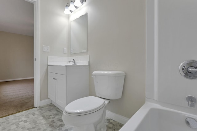 bathroom with vanity, toilet, and a bathing tub