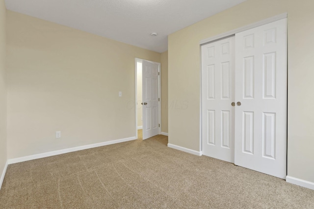 unfurnished bedroom featuring carpet floors and a closet