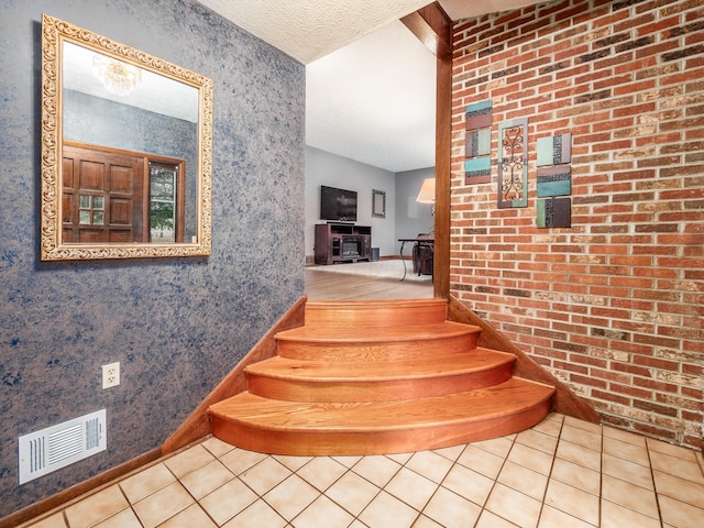 staircase featuring tile patterned flooring