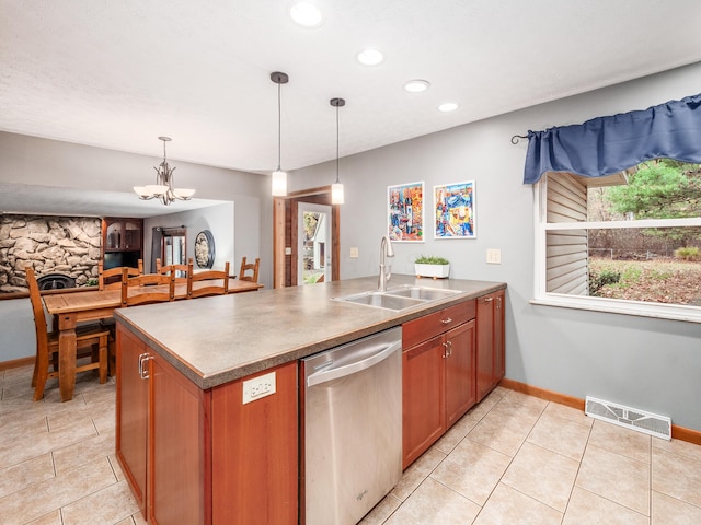 kitchen with sink, hanging light fixtures, stainless steel dishwasher, a fireplace, and a notable chandelier