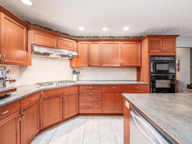 kitchen featuring backsplash, light tile patterned floors, and stainless steel appliances