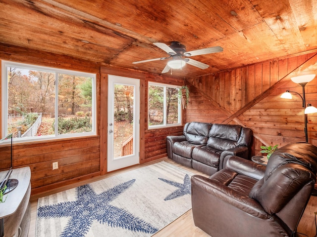 living room with log walls, hardwood / wood-style floors, ceiling fan, and wood ceiling