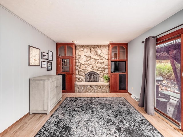 living room with a fireplace and light hardwood / wood-style flooring