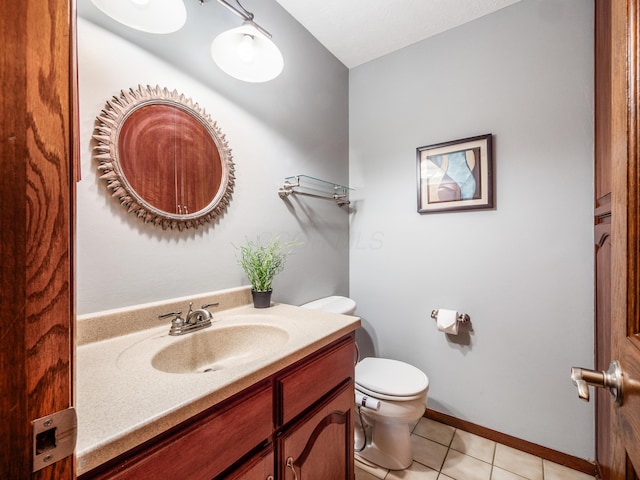 bathroom with tile patterned flooring, vanity, and toilet