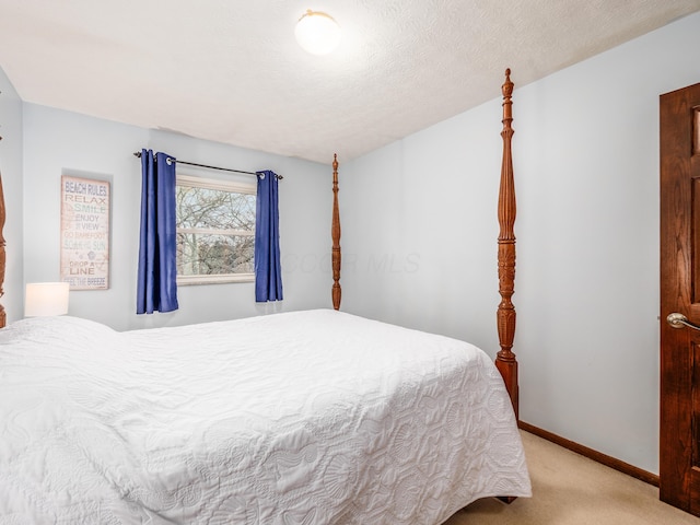 carpeted bedroom featuring a textured ceiling