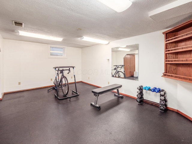 workout area with a textured ceiling