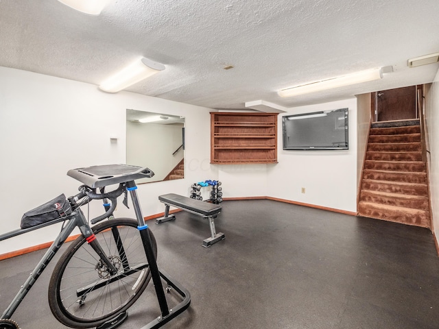 exercise area featuring a textured ceiling