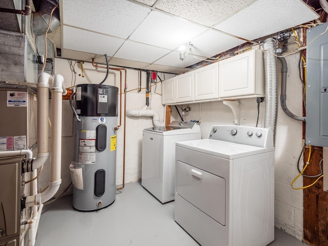 laundry room featuring washer and dryer, hybrid water heater, gas water heater, and cabinets