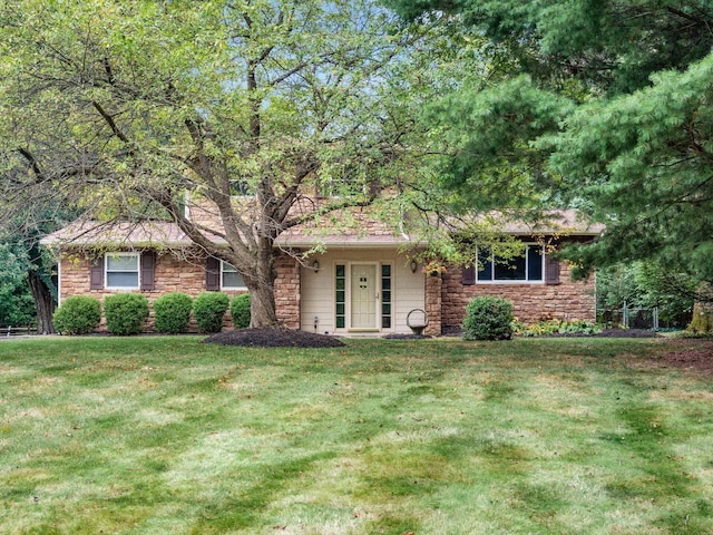 ranch-style home featuring a front yard