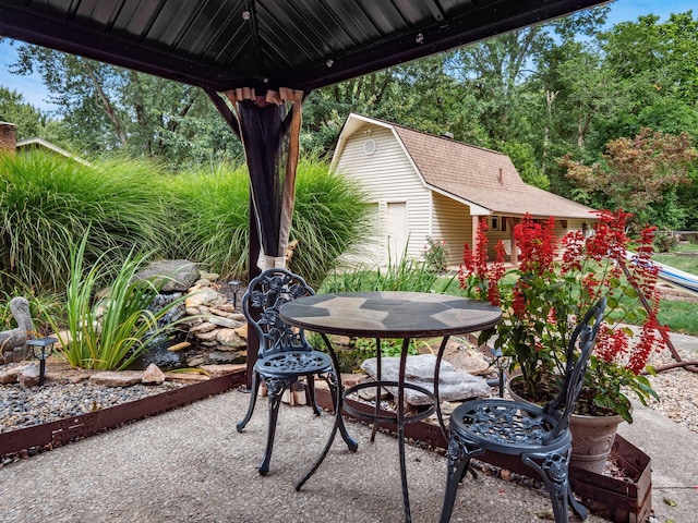 view of patio / terrace with an outbuilding and a fire pit