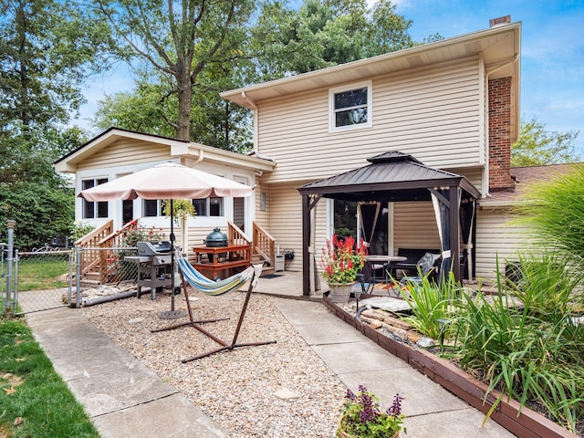 rear view of property with a gazebo