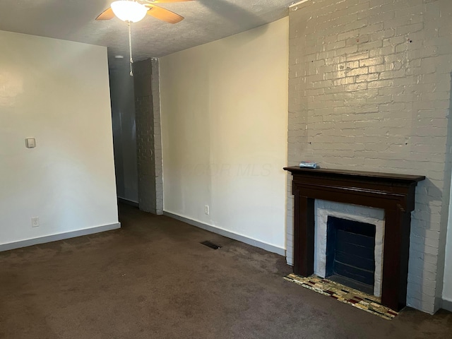 unfurnished living room with ceiling fan, a textured ceiling, and dark colored carpet