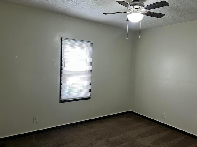 carpeted empty room featuring a textured ceiling and ceiling fan