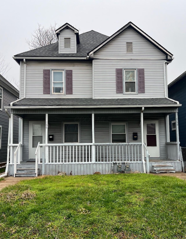 view of front of home with covered porch and a front yard