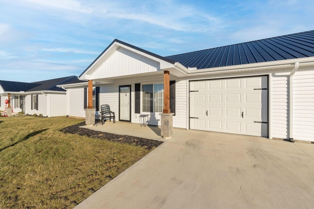 ranch-style house featuring a porch, a garage, and a front lawn