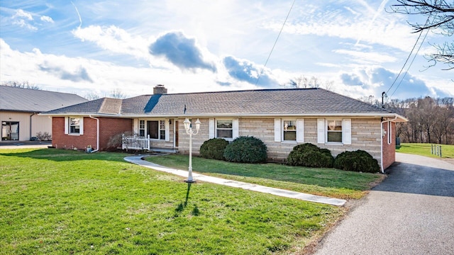 ranch-style house with a front lawn and a porch