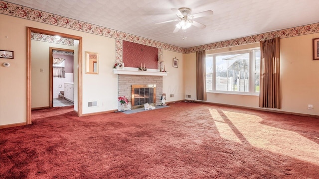 unfurnished living room with carpet, a textured ceiling, a brick fireplace, and ceiling fan