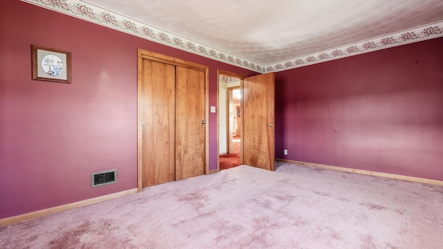 unfurnished bedroom featuring carpet floors and a closet