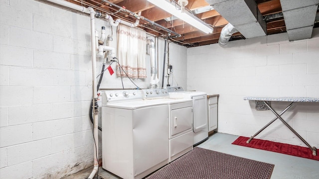 laundry room featuring cabinets and washer and dryer