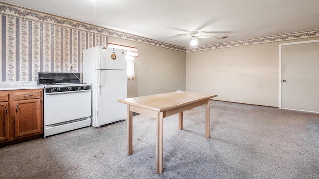 kitchen featuring ceiling fan, light colored carpet, and white appliances