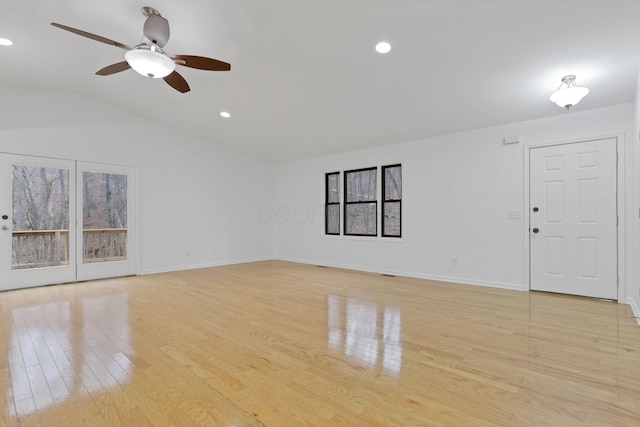 unfurnished living room featuring light hardwood / wood-style flooring, ceiling fan, and lofted ceiling