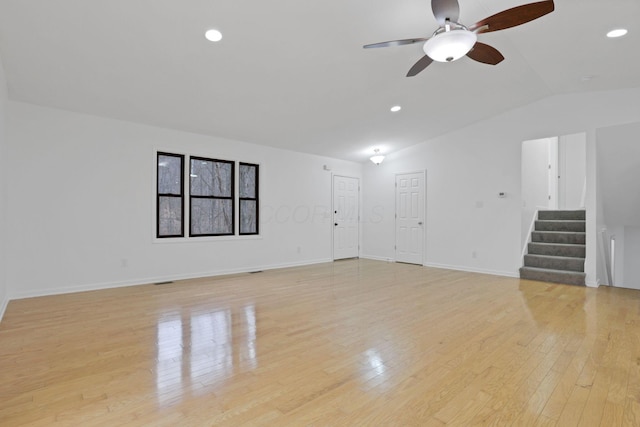 unfurnished living room with ceiling fan, light wood-type flooring, and lofted ceiling